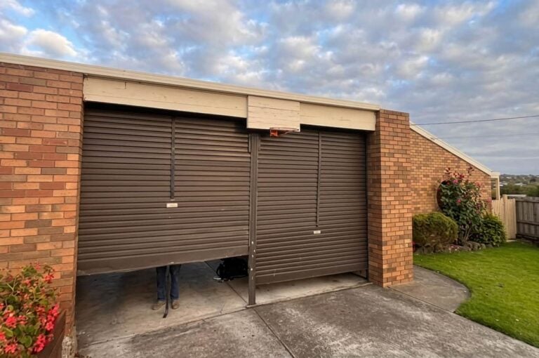 Roller garage door stopping before fully closing, illustrating a common garage door troubleshooting issue.