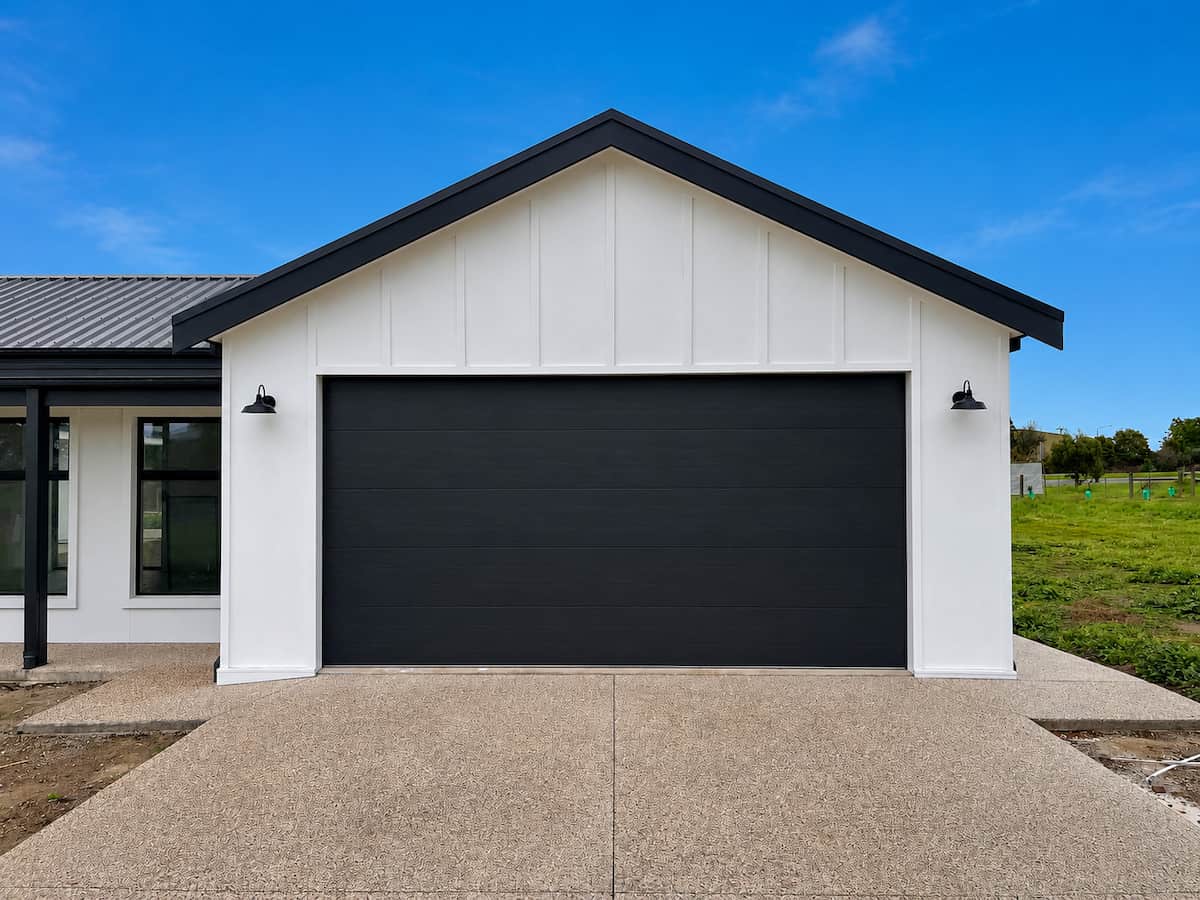 B&D Panelift sectional garage door featuring a Nullarbor Woodgrain profile in a Monument finish, automated with a B&D Smart Pro opener and battery backup system, professionally installed in Geelong by Ascent Garage Doors.