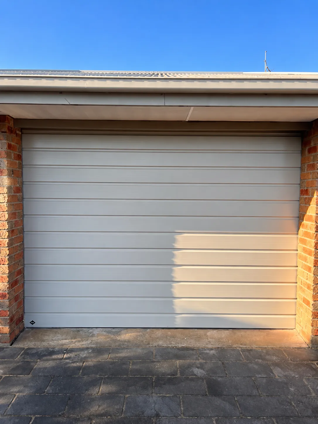 A B&D Roll-A-Door Neo roller garage door featuring a compact Neo Curtain profile in COLORBOND Surfmist, professionally installed with a Power Drive automatic opener in Geelong by Ascent Garage Doors.