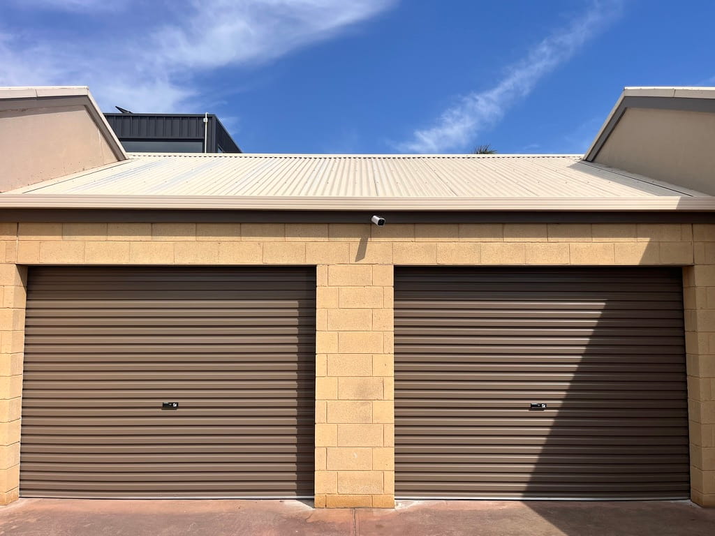 Dual Gliderol Standard roller garage doors in a COLORBOND Jasper finish, professionally installed on a brick garage in Anglesea by Ascent Garage Doors.