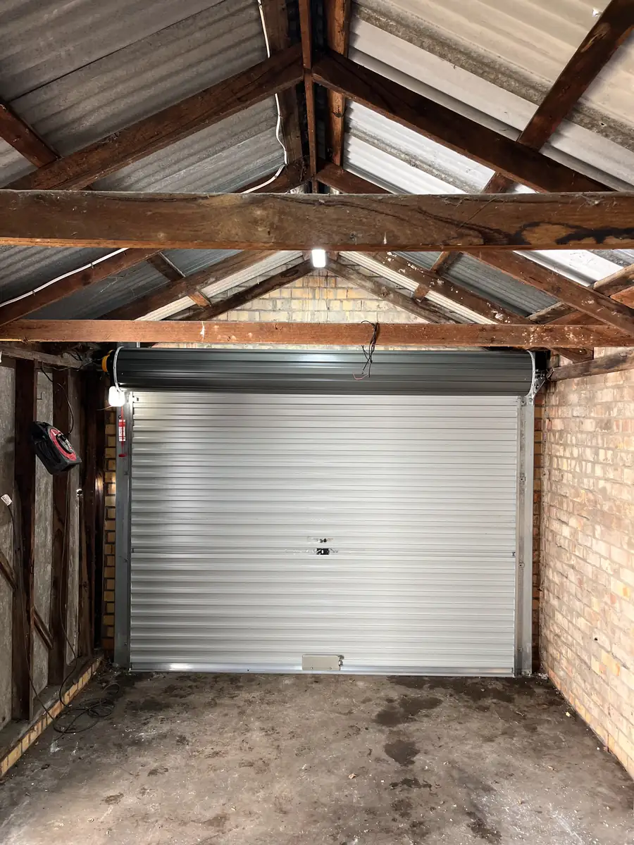 Inside view of a new Gliderol roller garage door with an ATA GDO-6v4 motor, in a brick garage with a timber roof frame in Colac